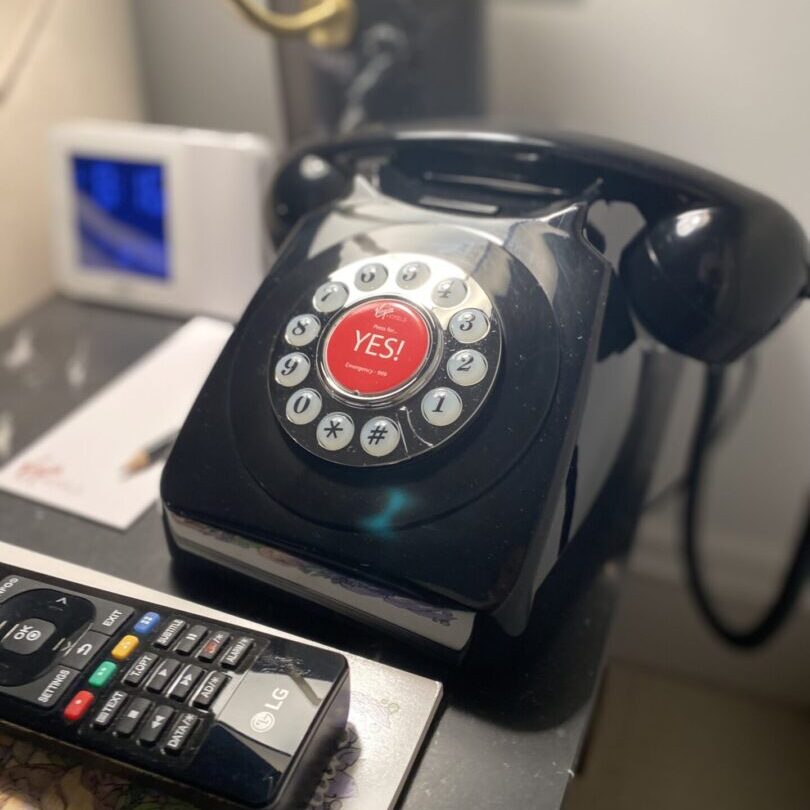 A black phone sitting on top of a table.